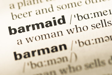 Fototapeta premium Close up of old English dictionary page with word barmaid