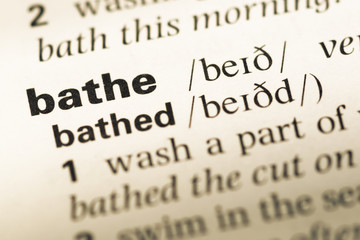 Obraz premium Close up of old English dictionary page with word bathe