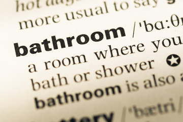 Obraz premium Close up of old English dictionary page with word bathroom