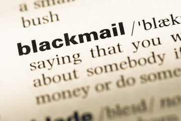 Obraz premium Close up of old English dictionary page with word blackmail