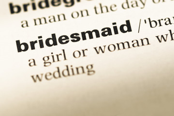 Close up of old English dictionary page with word bridesmaid