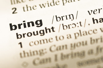 Obraz premium Close up of old English dictionary page with word bring