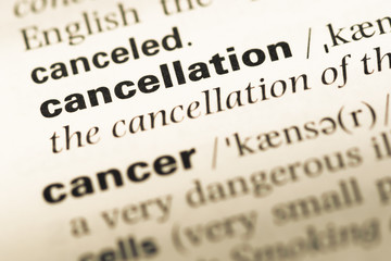 Obraz premium Close up of old English dictionary page with word cancellation