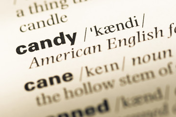 Obraz premium Close up of old English dictionary page with word candy