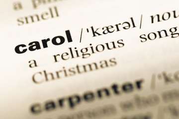 Close up of old English dictionary page with word carol