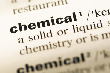 Close up of old English dictionary page with word chemical