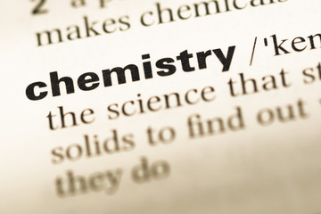 Obraz premium Close up of old English dictionary page with word chemistry