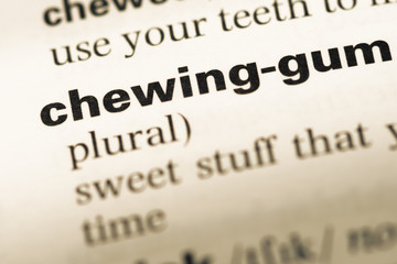 Close up of old English dictionary page with word chewing gum