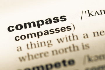 Obraz premium Close up of old English dictionary page with word compass