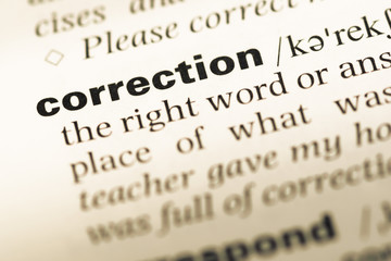 Close up of old English dictionary page with word correction