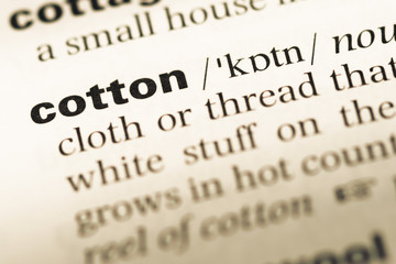 Obraz premium Close up of old English dictionary page with word cotton