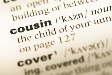 Close up of old English dictionary page with word cousin