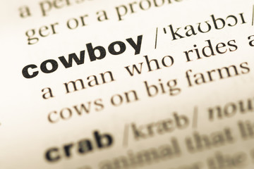 Fototapeta premium Zbliżenie starej strony słownika angielskiego z kowbojem słowa