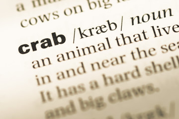 Close up of old English dictionary page with word crab