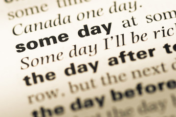 Obraz premium Close up of old English dictionary page with word some day