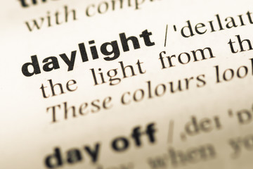 Obraz premium Close up of old English dictionary page with word daylight