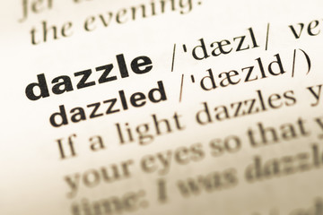 Fototapeta premium Close up of old English dictionary page with word dazzle