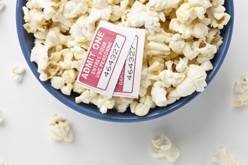 bowl of popcorn with movie ticket