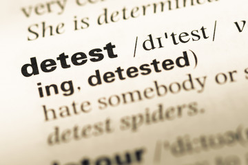 Close up of old English dictionary page with word detest