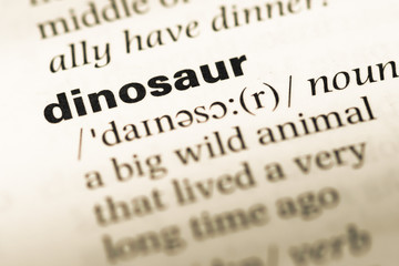 Close up of old English dictionary page with word dinosaur - obrazy, fototapety, plakaty