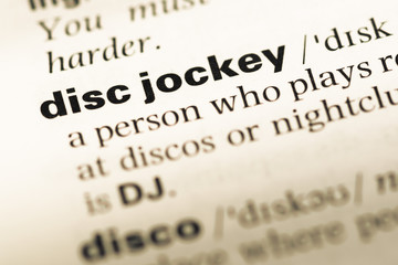 Close up of old English dictionary page with word disc jockey