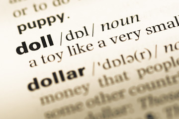 Obraz premium Close up of old English dictionary page with word doll