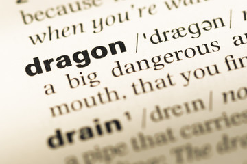 Obraz premium Close up of old English dictionary page with word dragon