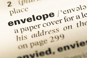 Obraz premium Close up of old English dictionary page with word envelope