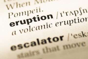 Fototapeta premium Close up of old English dictionary page with word eruption