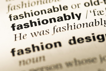 Close up of old English dictionary page with word fashionably