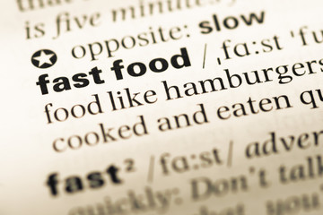 Close up of old English dictionary page with word fast food