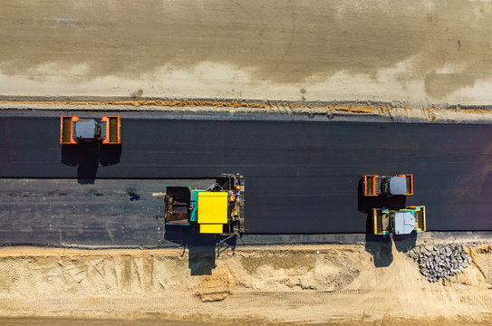 Road rollers working on the construction site aerial view