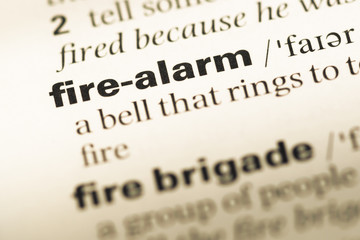 Close up of old English dictionary page with word fire alarm