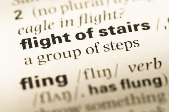 Close up of old English dictionary page with word flight of stai