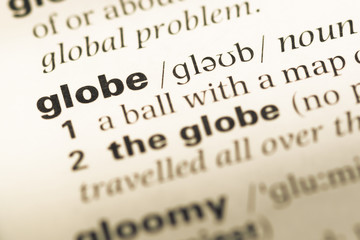 Close up of old English dictionary page with word globe