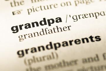 Fototapeta premium Close up of old English dictionary page with word grandpa