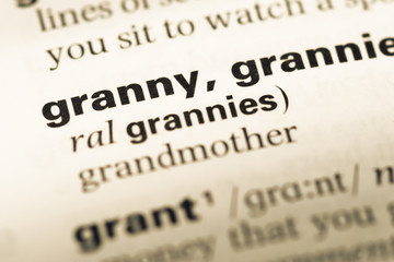 Fototapeta premium Close up of old English dictionary page with word granny