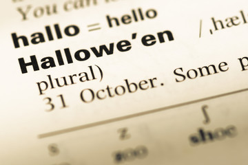 Close up of old English dictionary page with word halloween
