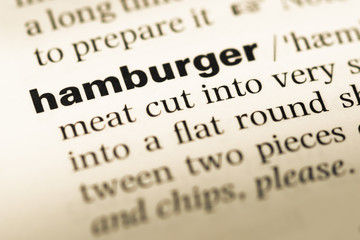 Obraz premium Close up of old English dictionary page with word hamburger