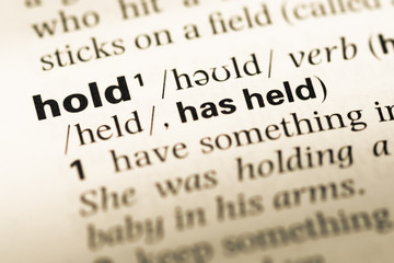 Fototapeta premium Close up of old English dictionary page with word hold
