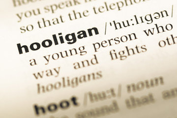 Close up of old English dictionary page with word hooligan