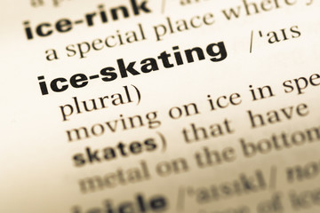 Close up of old English dictionary page with word ice skating