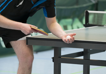 table tennis player serving, closeup