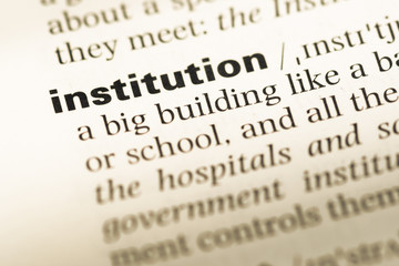 Close up of old English dictionary page with word institution