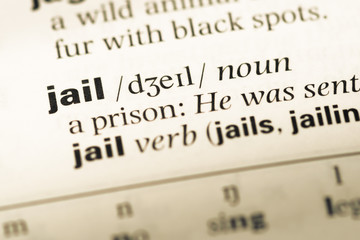 Close up of old English dictionary page with word jail