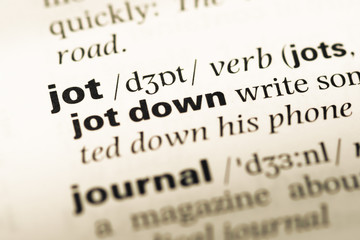 Close up of old English dictionary page with word jot