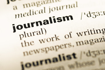 Fototapeta premium Close up of old English dictionary page with word journalism