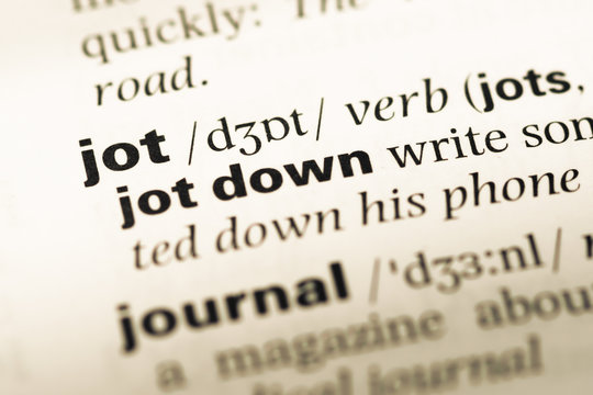 Close up of old English dictionary page with word jot