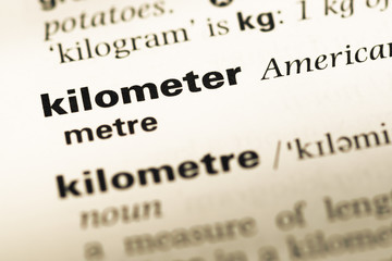 Obraz premium Close up of old English dictionary page with word kilometer