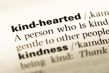 Obraz premium Close up of old English dictionary page with word kind hearted